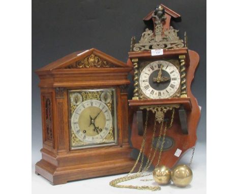 A late 19th century oak cased mantel clock framed with pediment and flanking acanthus pilasters, German stamped W&amp;H to th