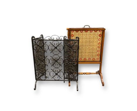 An Edwardian mahogany adjustable fireguard with rectangular needlework panel 83 x 54 x 37cm, together with a modern black pai