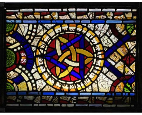 A 19th century brass fireguard with ribbed frame enclosing a stained glass panel. The panel with celtic knot central design, 