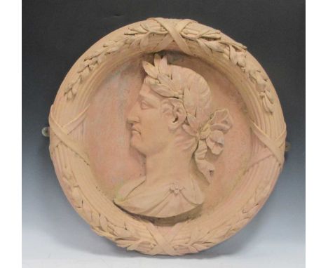 A terracotta-effect resin garden roundel, moulded as a Roman emperor; together with a terracotta garden pillar and a plant po