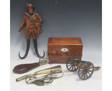A Regency burwood tea caddy; an Alpine carved wood figure of a man carrying a hare with animal horns for legs; a brass and le