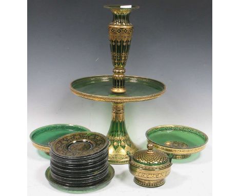 Bohemian style sweetmeat dessert service with gilded decoration over dark green glass, highlighted with white enamel details.