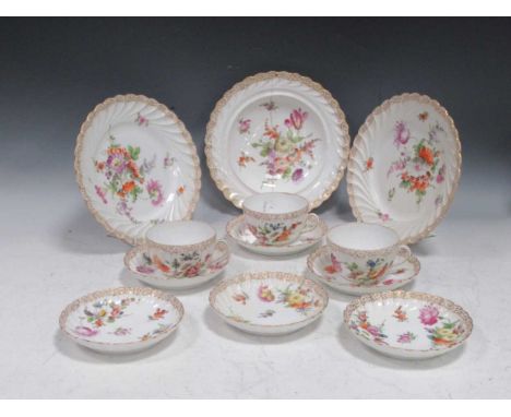 A Dresden part tea service decorated with floral bouquets over swirled and scalloped shape; six side plates, ten saucers, jug