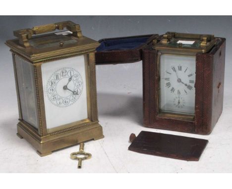 Two early 20th century brass carriage clocks, one with Swiss movement, Roman chapter ring and subsidiary dial in a leather ca