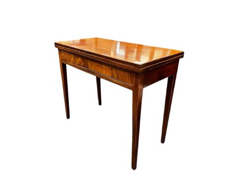 A late 19th century mahogany fold-over card table with satinwood stringing and set on square section tapering leg, inset draw