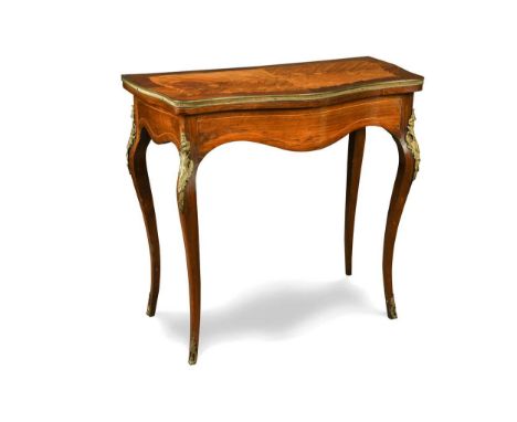 A Louis XV style serpentine satinwood fold-over card table, 19th century,  the fold-over swivel top with floral inlay and gil