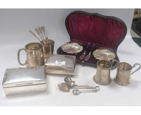 A collection of silverware including christening mugs, flatware, cigarette boxes and a cased pair of shell dishes with knives