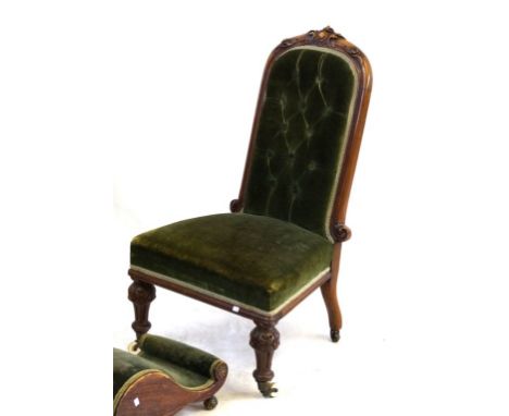 A Victorian carved walnut show wood framed nursing chair
The buttoned back and flared seat upholstered in green draylon, rais