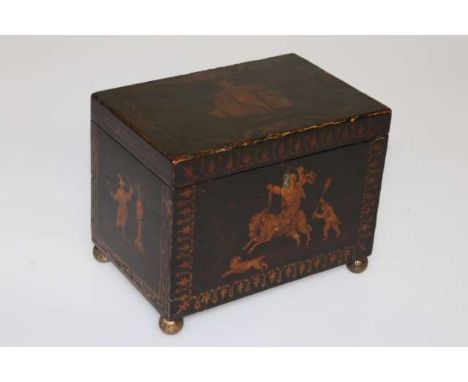 AN 18TH CENTURY BLACK JAPANNED CHINOISERIE TEA CADDY, of rectangular form, decorated with figures, raised on cast brass ball 