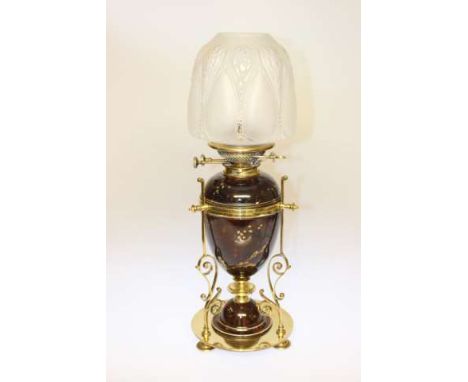 A 19TH CENTURY BRASS AND POTTERY OIL LAMP, the metalwork of Benson type, the circular base with domed pottery inset, issuing 