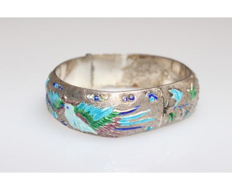 A CHINESE BANGLE, silver decorated with birds and foliage picked out in enamels, stamped. 7cm