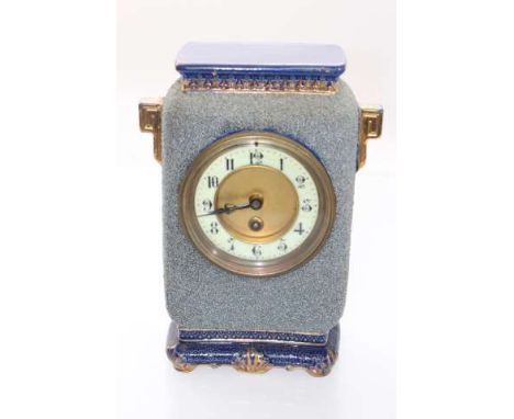 A FRENCH POTTERY MANTEL CLOCK, late 19th Century, the case with shredded ground and embellished with gilding, the dial with A