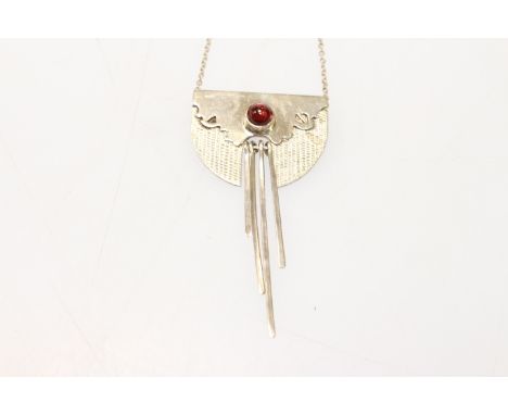 A GARNET AND SILVER NECKLACE, the four articulated strands of differing lengths set to the bottom centre of an unusual shaped