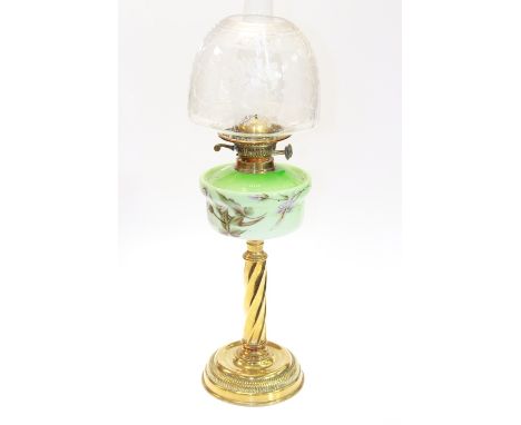 A 19TH CENTURY BRASS AND CASED-GLASS OIL LAMP, the dished circular base issuing a wrythen stem below a floral painted green-g