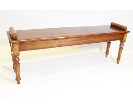 A WALNUT WINDOW BENCH, raised on turned tapering legs. 137cm