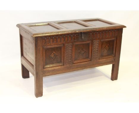 AN OAK COFFER, 17th/18th Century, the moulded three-panel lid above a three-panel front, each panel inlaid with a lozenge, wi
