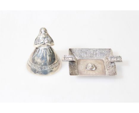 A WHITE-METAL TABLE BELL, in the form of a girl with a spreading dress, stamped "925", 8.5cm; together with A PERUVIAN STERLI