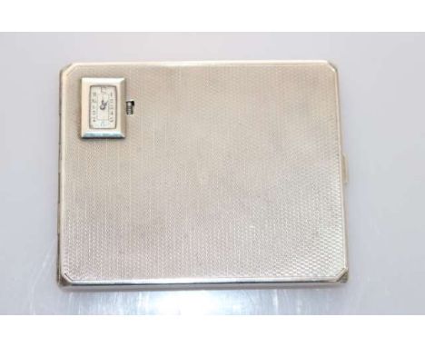 A GEORGE V SILVER CIGARETTE CASE WITH INSET WATCH, Smith & Bartlam, Birmingham 1930, the engine-turned case inset to one corn