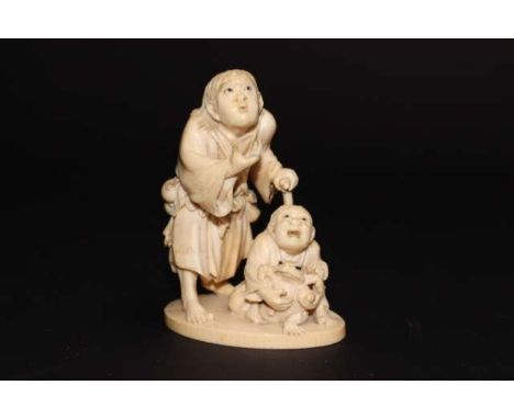 A JAPANESE IVORY OKIMONO, Meiji period (1868-1911), carved as a wood chopper sitting on a trunk, unsigned, 11cm; together wit