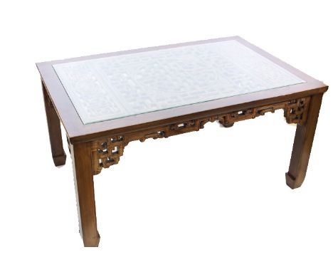 A CHINESE HARDWOOD DINING SUITE, the table with rectangular top inset with glass above a fret carved panel, over a fret carve