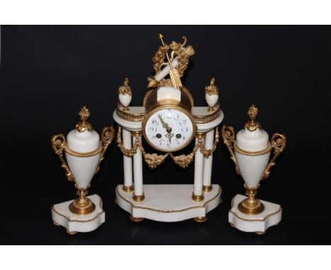 A FRENCH WHITE MARBLE AND GILT-METAL GARNITURE DE CHEMINEE, IN NEOCLASSICAL STYLE, c.1900, the circular dial with Arabic nume
