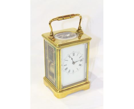 A FRENCH BRASS-CASED STRIKING CARRIAGE CLOCK, the white enamel dial with Roman numerals and outer Arabic numerals. 12.5cm exc