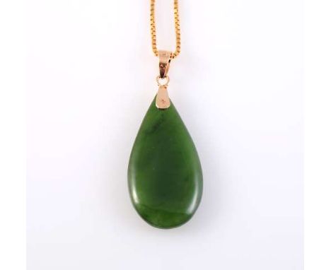 A JADEITE AND GOLD PENDANT, the tapering pear shaped jadeite simply set on an articulated link to the bottom of an oval shape