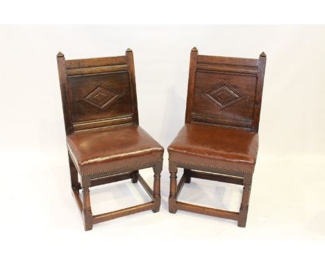 A PAIR OF LANCASHIRE OAK BACKSTOOLS, LATE 17TH CENTURY, each with lozenge carved back panel above a now stuffed over seat, ra