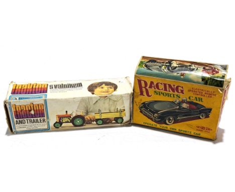 A tinplate &amp; plastic constructed boxed pair, to include a tinplate tractor and trailer (Eastern European) and an Empire M