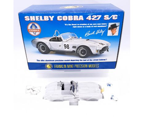 Franklin Mint, a boxed 1:24 scale B11YF05 Shelby Cobra 427 S/C - in brushed aluminium finish with black interior and racing n