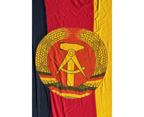 East Germany, very large East Germany fabric flag, stitched design with attached round insignia. The flag features a coat of 
