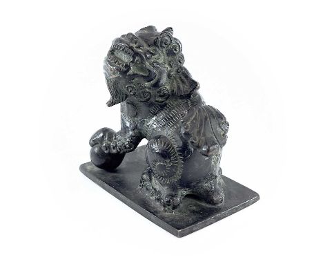 A Chinese bronze of model of a dog of fo, the base. with an apocryphal six-character Xuande mark, height 8.5cm, width 8cm, de