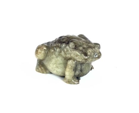 A Chinese jade model of a toad, height 4cm, width 4cm, depth 6.5cm.Generally good condition. The front right foot has two sho