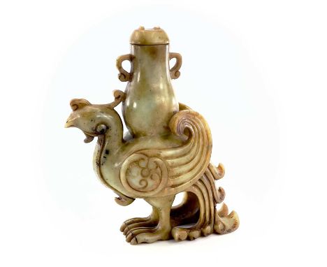 A Chinese jade carved model of a phoenix, 20th century, supporting an archaic vase, height 22cm, width 18cm, depth 7cm.