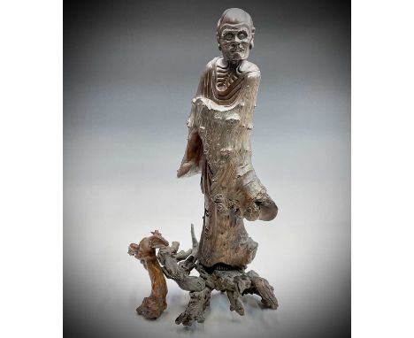 A Chinese carved rootwood figure of a man in a robe, 19th century, the figure in two sections, height 67cm, width 32cm togeth