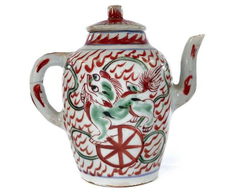 A Chinese porcelain teapot, 18th century, decorated with red and green dogs of fo, height 14.5cm, width 14cm.hirline around c