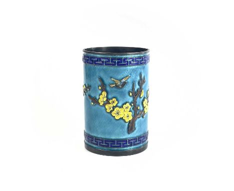 A Chinese silver and enamel brush pot, decorated in relief with a flowering tree and birds, height 11cm, diameter 7.5cm.