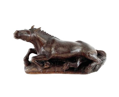 A Chinese carved wood model of a horse, 19th century, on a later base, height 20cm, width 38cm, depth 12.5cm.