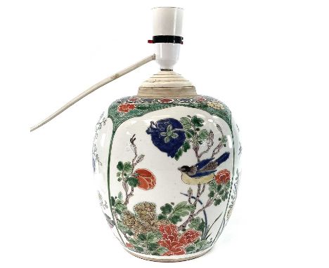 A Chinese famille verte porcelain jar, 19th century, lacking cover and coverted to a lamp, decorated enamels with four arched