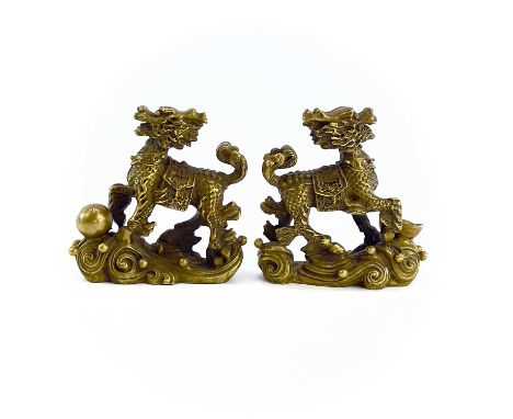 A pair of Chinese gilt metal scroll weights in the form of dogs of fo, height 8.3cm, width 8cm, depth 3cm.