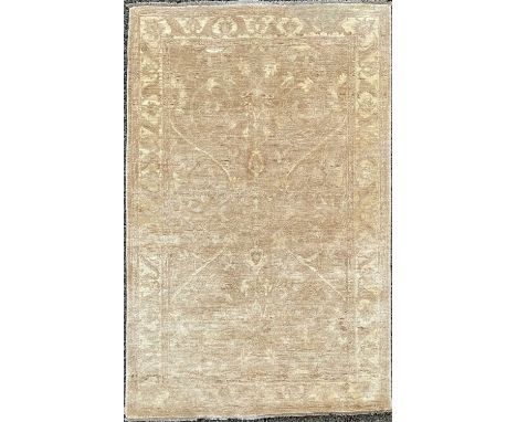 A Chobi rug of Ziegler design, the light brown field with a central lobed medallion, within a cream angular vine border, 246 