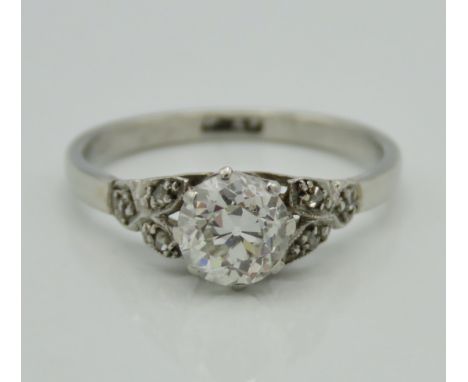 A platinum diamond ring set with approx. 0.85ct old cut centre stone of good colour & clarity with small stones on shoulders,