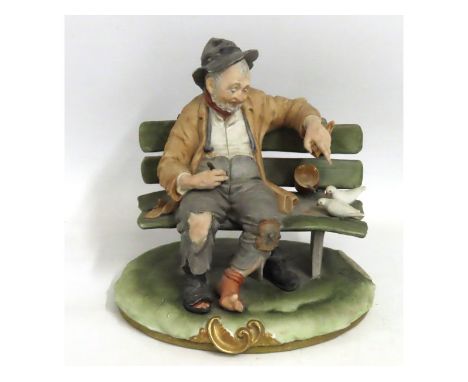 A 1970s Capodimonte porcelain figure group by Bruno Merli, 'Man on bench with Doves'