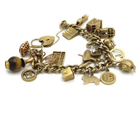 A 9ct gold charm bracelet featuring an abacus, ballerina, mouse ran up the clock, piano & typewriter, 64.2g