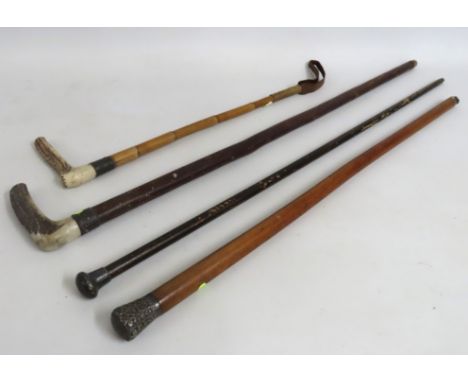 A silver collared riding crop twinned with three silver & white metal walking canes including Malacca