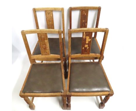 Four vintage Ercol oak chairs, some losses to veneer to splats, 855mm high to back