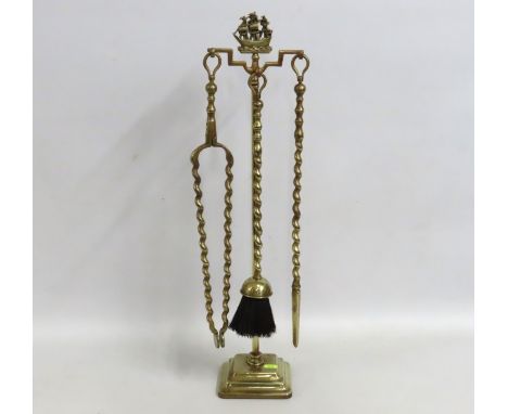 A brass companion set with the "Fowey Ship" finial to the top, 677mm tall