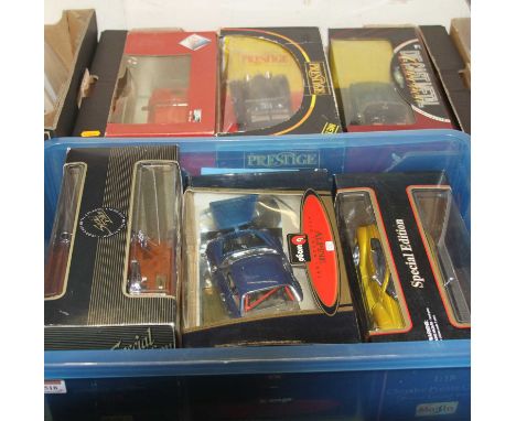 Two trays containing six various boxed 1/18 scale diecast miniatures by Burago and Maisto