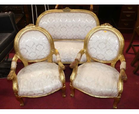 A French gilt wood three-piece child's salon suite comprising two-seater sofa, and a pair of matching armchairs, each pale fl