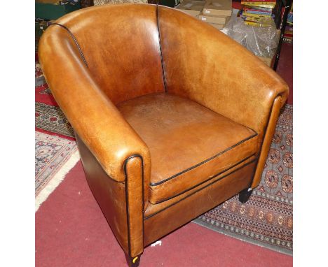 A contemporary tan leather tub armchair, raised on tapering supports, width 78cmSome general wear, marks and light scratches,